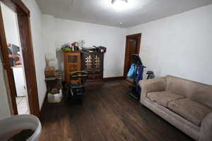 Living area with hardwood / wood-style floors and a textured ceiling