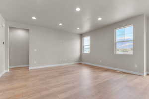 Spare room featuring recessed lighting, light wood finished floors, and a mountain view