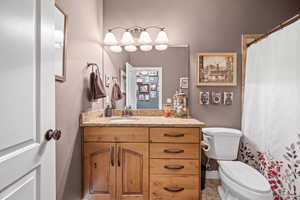 Bathroom featuring a shower with shower curtain and vanity