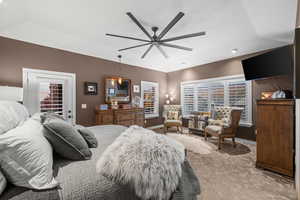 Primary bedroom featuring a ceiling fan and baseboards