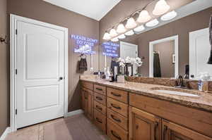 Bathroom with light tile patterned flooring, double vanity, and a shower with shower curtain