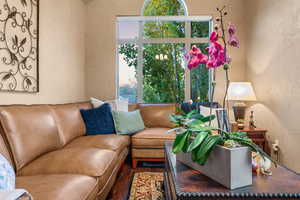 Living room with wood finished floors and a textured wall