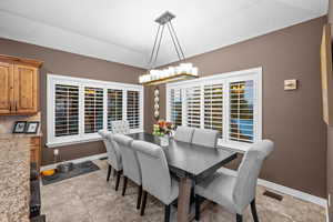 Dining area featuring healthy amount of natural light and vaulted ceiling