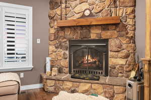 Detailed view of wood finished floors and a fireplace