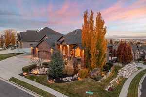 French country inspired facade featuring brick siding and driveway