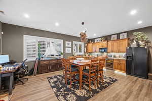 Dining room featuring light wood finished floors, recessed lighting, wine cooler, and an office area