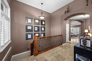 Hall with arched walkways and baseboards