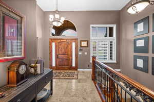 Foyer featuring a chandelier and a towering ceiling