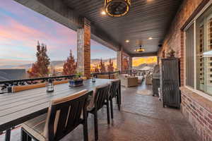 Patio terrace at dusk featuring a mountain view, outdoor dining space, an outdoor living space, and a patio area