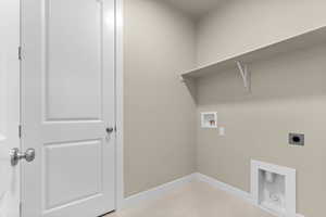Laundry room featuring washer hookup, light tile patterned floors, and electric dryer hookup