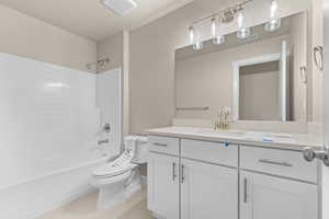 Full bathroom featuring shower / washtub combination, light tile patterned floors, and vanity