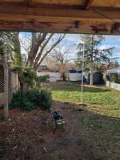 Fenced backyard featuring a shed