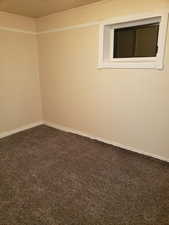 Unfurnished room featuring carpet floors and baseboards