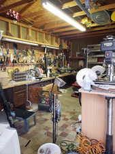 Below grade area with tile patterned floors and a workshop area