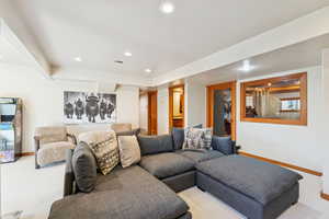 Carpeted living area featuring baseboards and recessed lighting