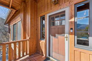 Doorway to property featuring board and batten siding and a mountain view