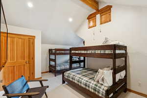 Bedroom featuring recessed lighting, light colored carpet, and a closet