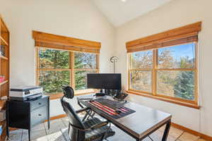 Office area featuring vaulted ceiling and baseboards
