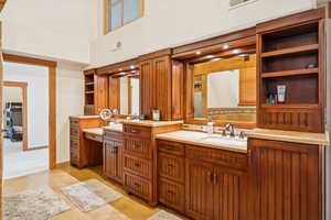 Full bathroom with double vanity, a shower, and light tile patterned flooring