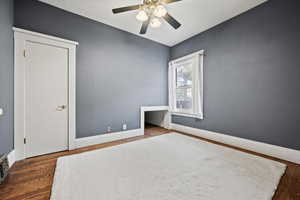Unfurnished bedroom with wood finished floors and a ceiling fan