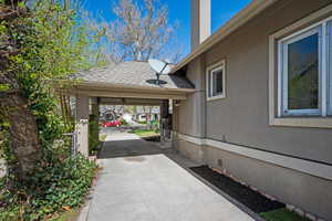 View of home's exterior with crawl space, a shingled roof, driveway, and stucco siding