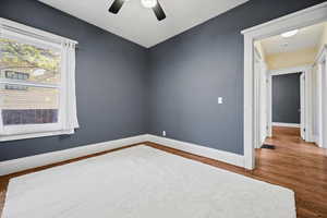 Unfurnished room featuring wood finished floors and ceiling fan