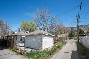 View of home's exterior featuring roof with shingles, a chimney, and a mountain view