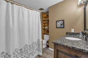 Full bath featuring a shower with curtain and vanity