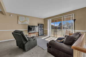 Carpeted living room with baseboards