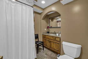 Bathroom with vanity, curtained shower, and light tile patterned flooring