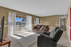 Living area with carpet floors and a chandelier