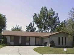 Ranch-style house with a front lawn and concrete driveway