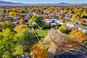 Aerial view of residential area featuring mountains and property parcel outlined