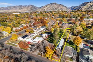 Aerial perspective of suburban area featuring mountains and property boundaries highlighted