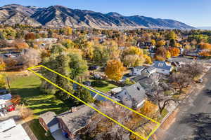 Aerial perspective of suburban area with a mountainous background and property boundaries highlighted