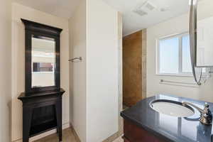 Bathroom with vanity and a tile shower