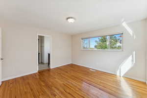 Empty room with light wood-type flooring and baseboards