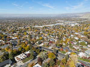 Aerial view of property and surrounding area featuring nearby suburban area
