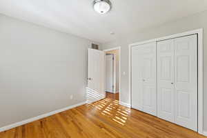 Unfurnished bedroom with a closet and light wood-style floors