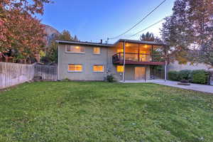 Back of property featuring a patio area, brick siding, an outdoor fire pit, and a wooden deck