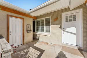 Entrance to property with brick siding