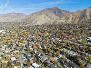 View of property location featuring mountains and nearby suburban area