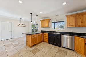 Kitchen with decorative light fixtures, brown cabinetry, a peninsula, dishwasher, and recessed lighting