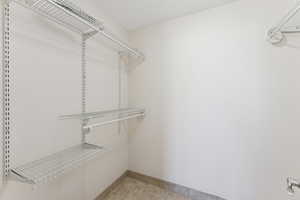 Spacious closet with light tile patterned floors