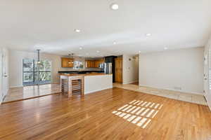 Unfurnished living room featuring healthy amount of natural light, light tile patterned floors, and recessed lighting