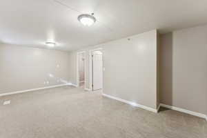 Basement with light colored carpet