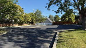 View of asphalt road with curbs