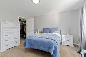 Spacious primary suite features an en-suite bath and two walk-in closets
