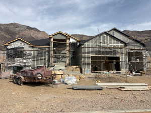 Property under construction with a mountain view and an outbuilding