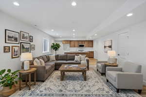 Enhanced staging Living room with recessed lighting and light wood-style floors